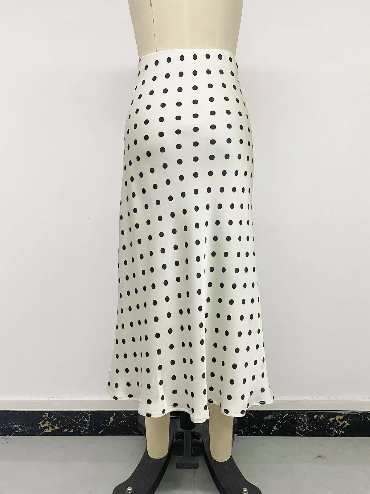 Beige polka dot stretch midi skirt on mannequin, full front view