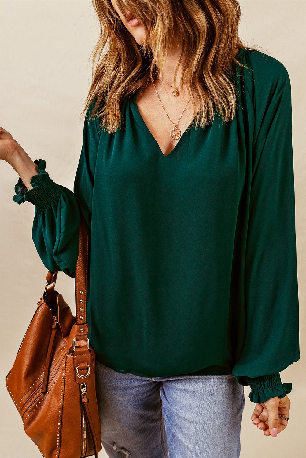 Green V-neck lantern sleeve blouse with long loose sleeves and elastic ruched cuffs