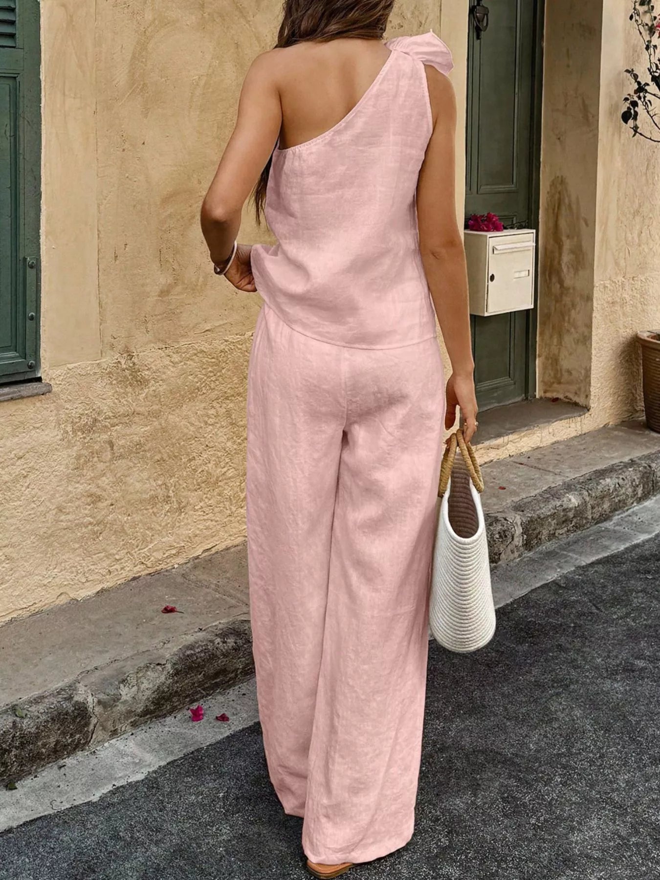 One-shoulder embellished top and pants set in pink, back view with wide-leg pants