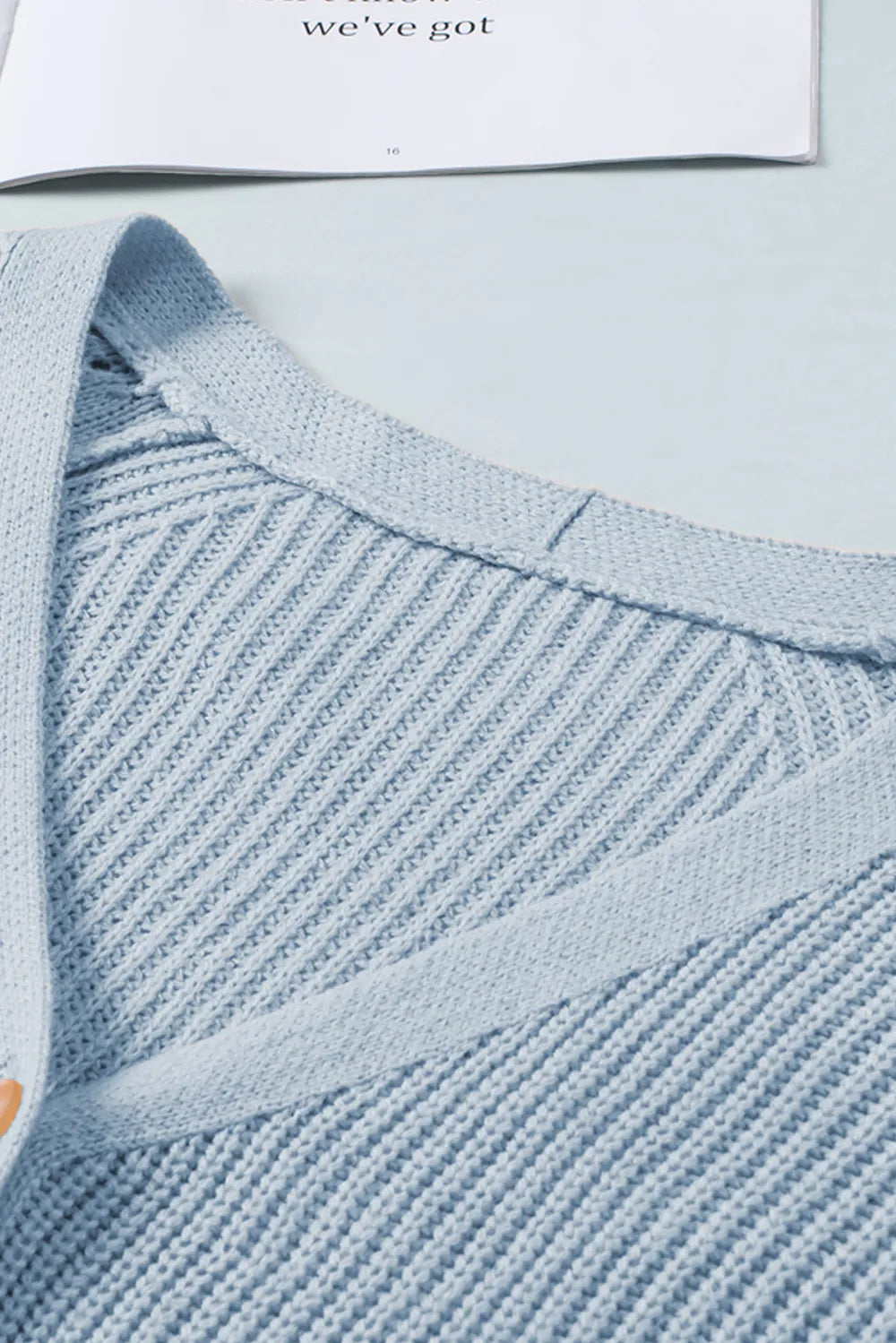 Light blue openwork V-neck with ribbed trim and button placket
