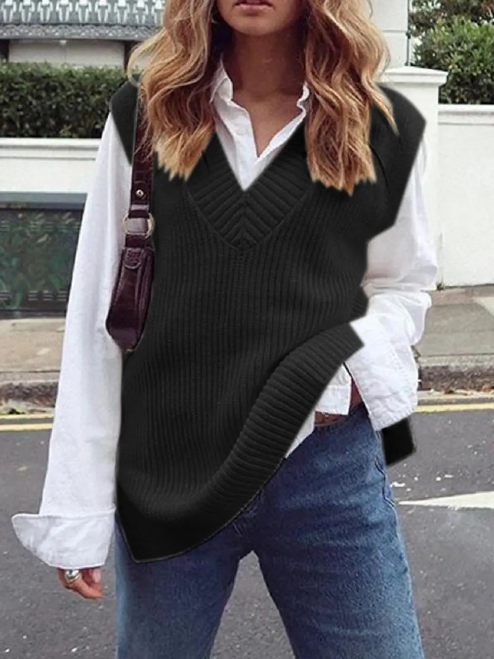 Black ribbed V-neck sleeveless sweater vest with chevron knit pattern.
