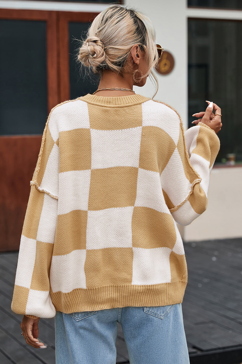 Tan and white checkered sweater, crew neck ribbing and relaxed drop-shoulder fit