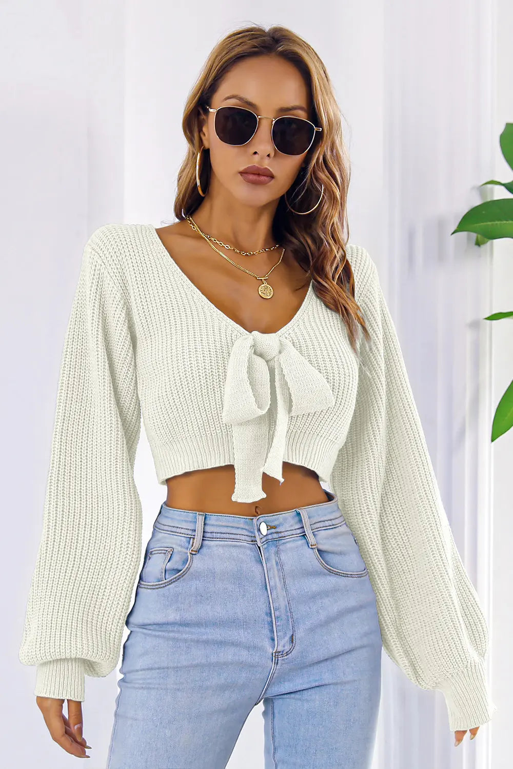 Cream bow V-neck cropped sweater with long sleeves and tied front bow