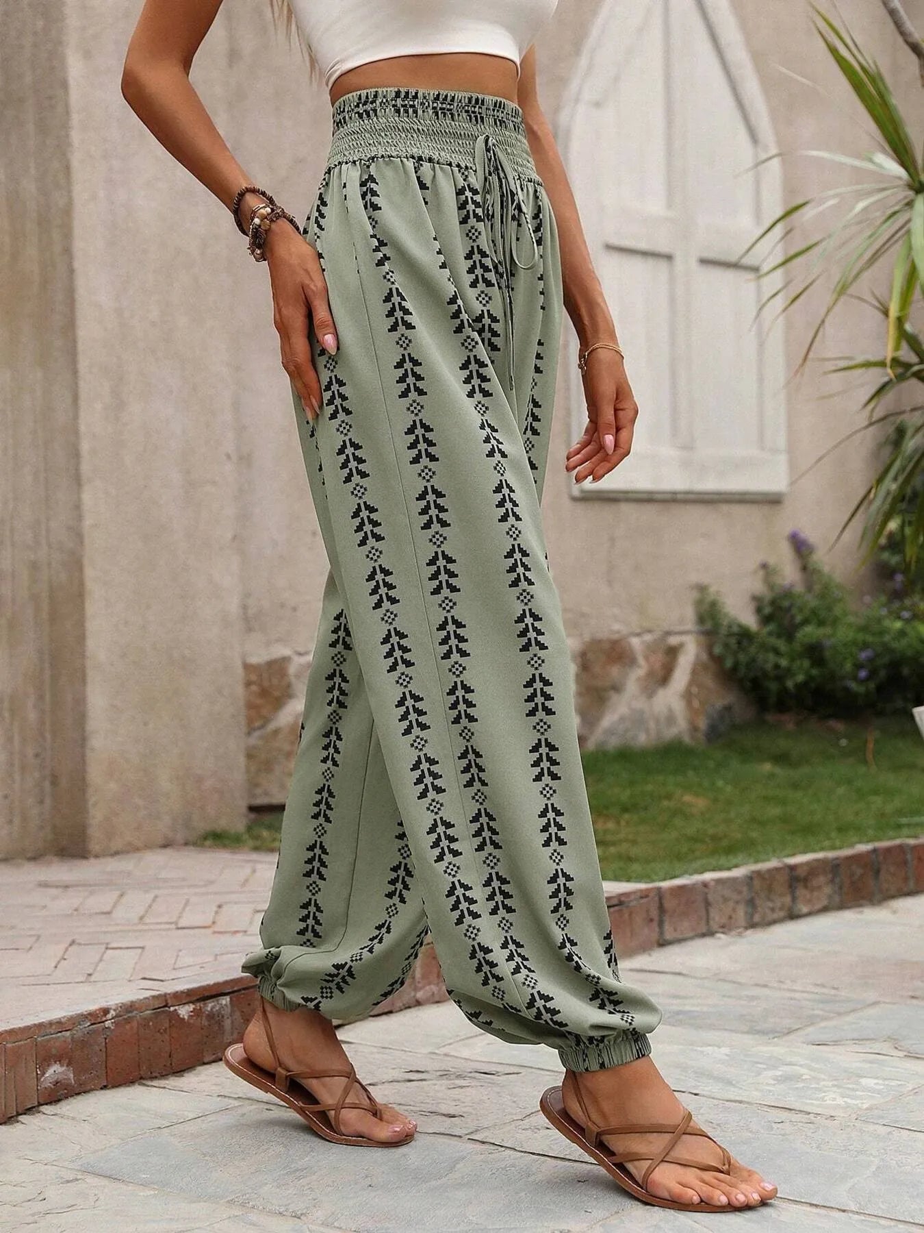 Wide-leg printed pants, muted green with white vertical print and gathered elastic waist