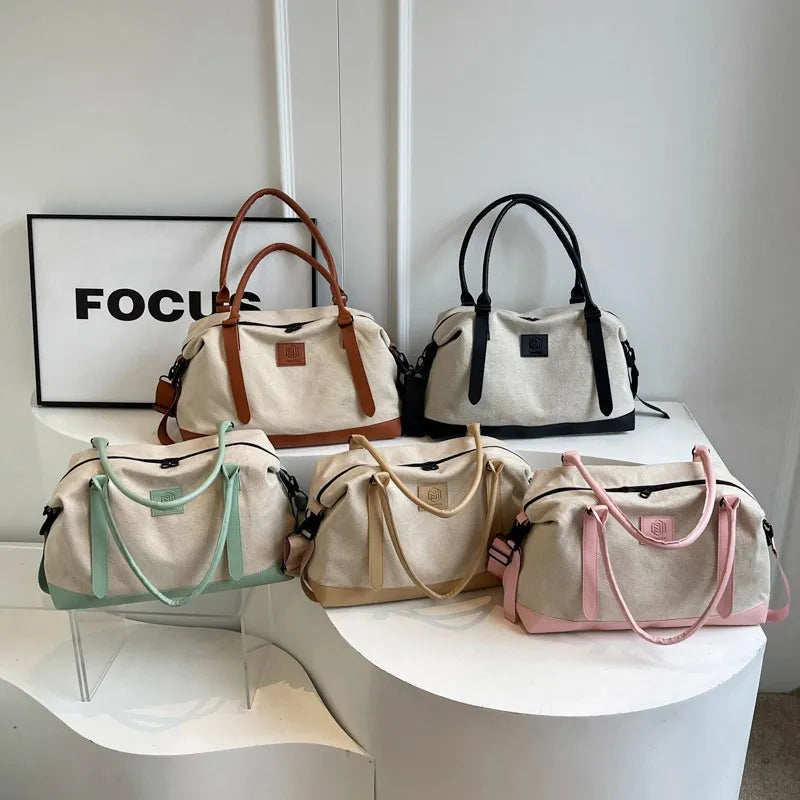 Large polyester duffle bags with contrast handles, shown in several colors