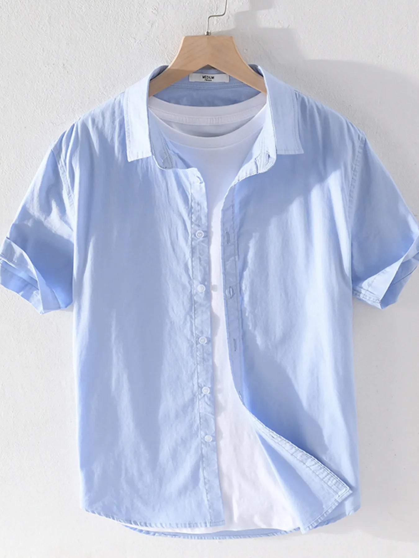 Men's short sleeve button-up shirt, light blue with front buttons and pointed collar