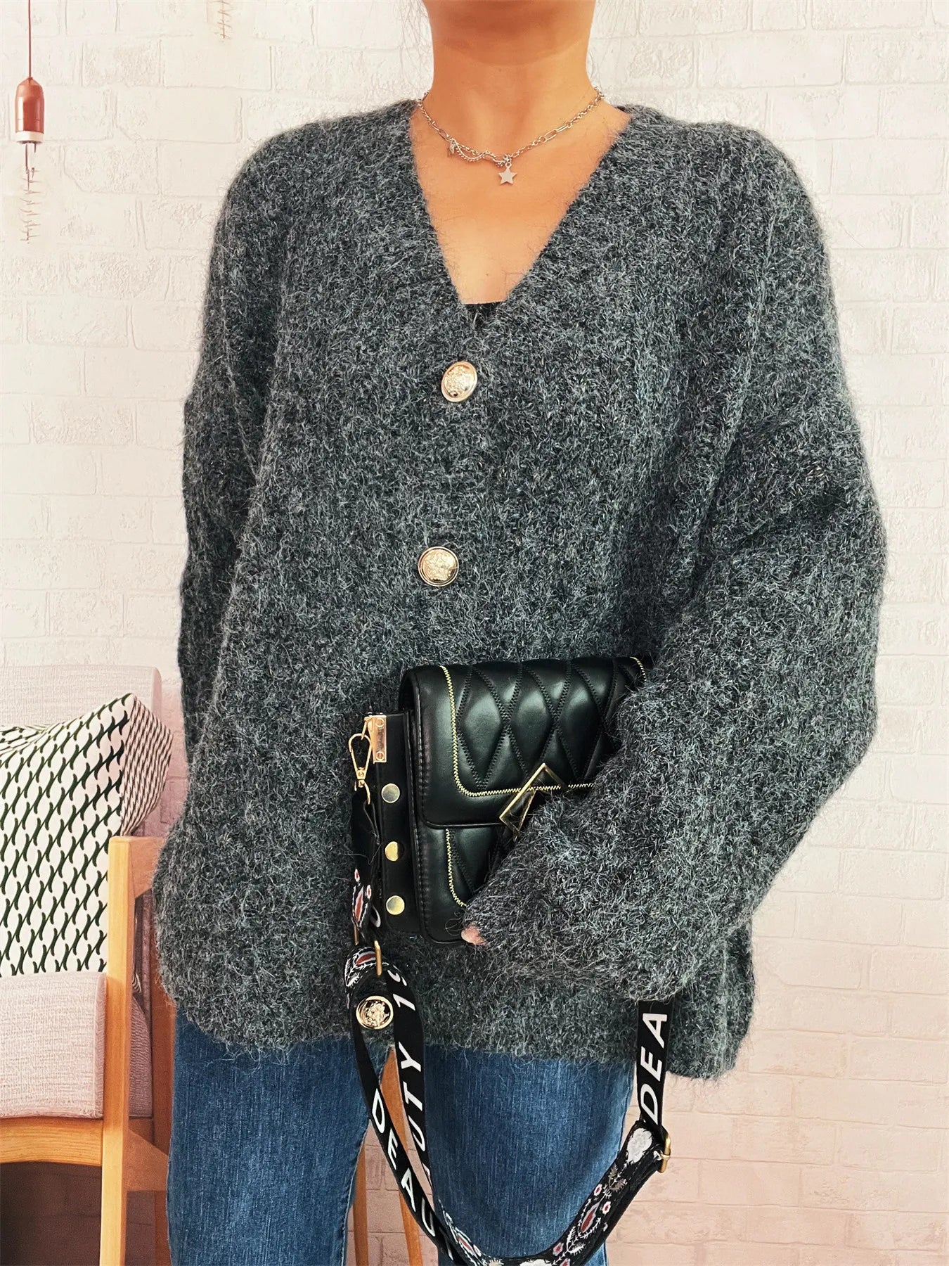Dark gray V-neck knit button cardigan with long sleeves and round gold buttons