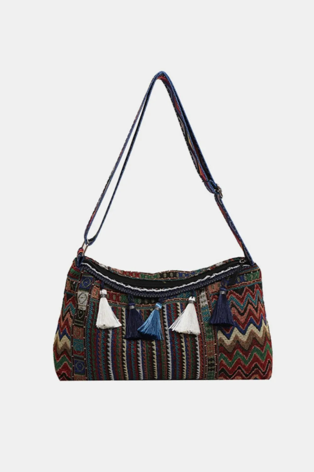 Tassel shoulder bag with adjustable strap, dark multicolor patterned fabric with hanging tassels.