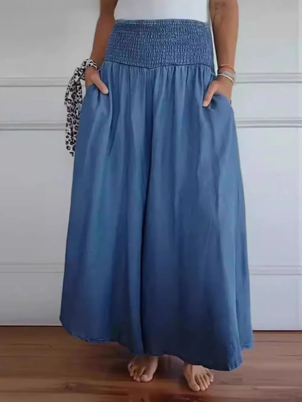 Dusty blue smocked wide-leg pants with gathered waist and airy pleated drape
