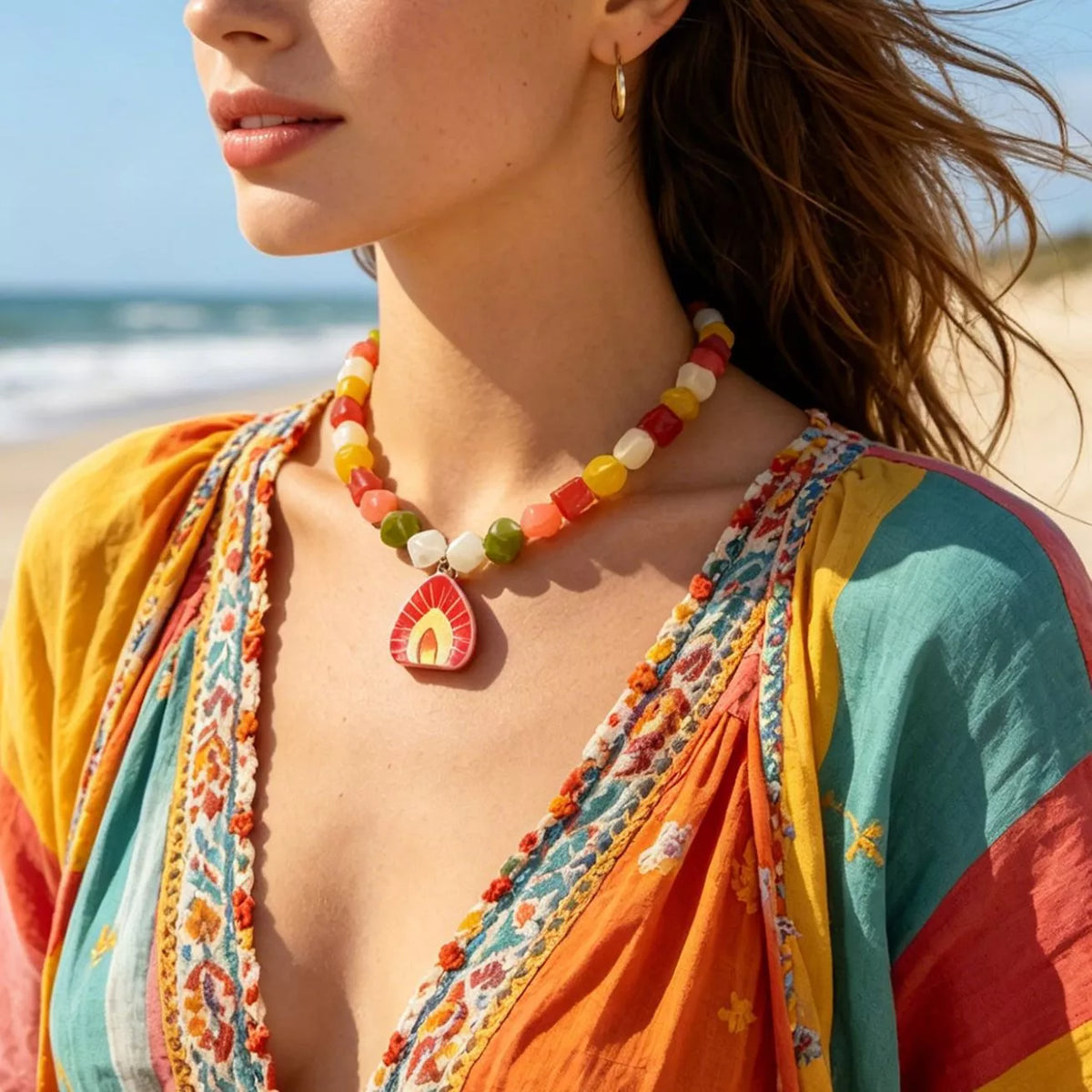 Boho beaded necklace featuring multicolor cube beads and a red arched pendant