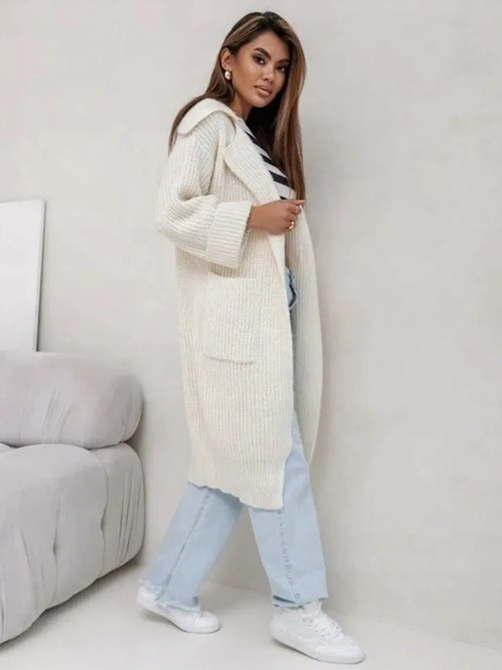 Cream long cardigan with collared neck, dropped shoulders, and side pockets