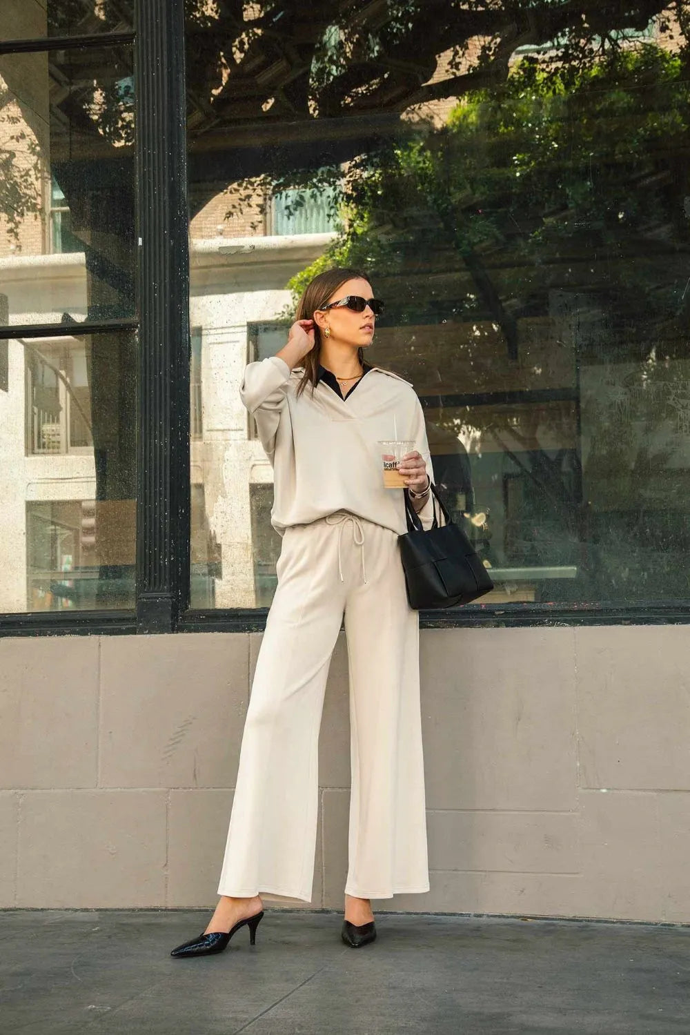 Ecru wide-leg drawstring pants with side pockets, loose fit through the legs