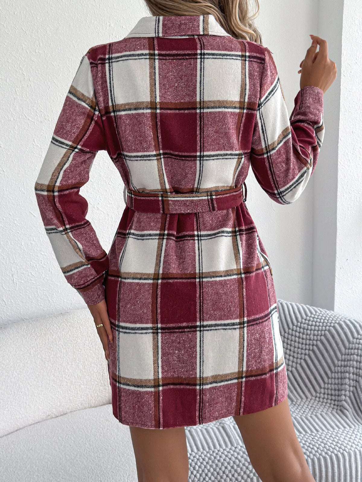 Back view of burgundy plaid belted button shirt dress with collar and long sleeves.