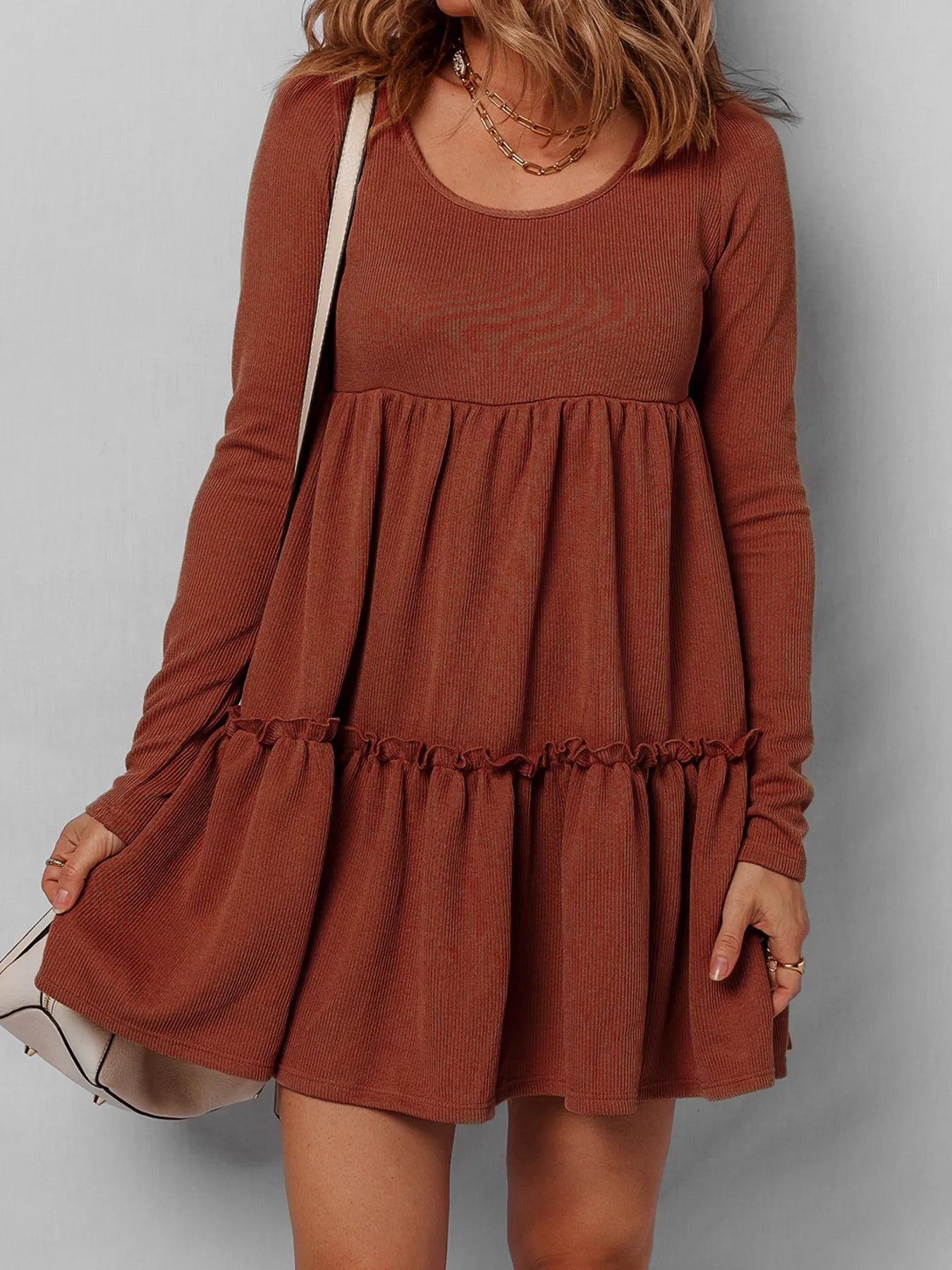 Frill tiered long-sleeve mini dress in rust color with ruffled tiers.