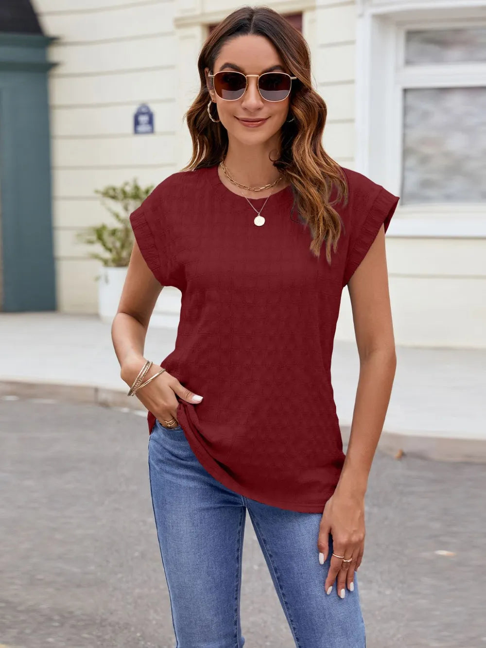 Textured round neck cap-sleeve T-shirt in wine red with short sleeves and loose drape.