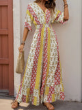 Multicolor printed V-neck jumpsuit with ruffled hem and cinched waist, short flutter sleeves