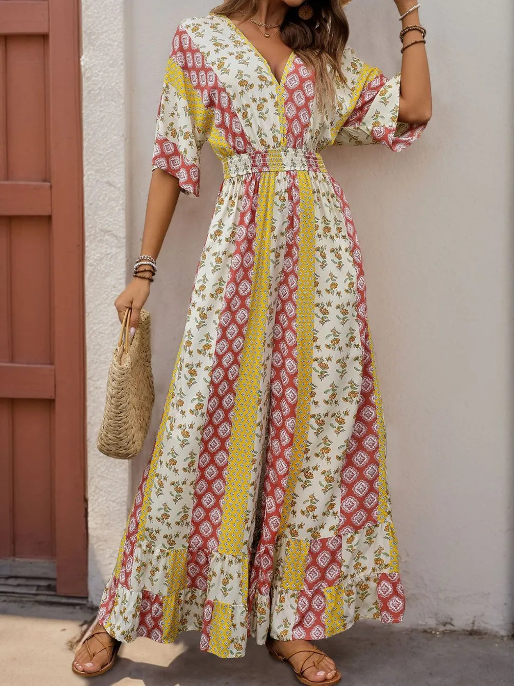 Multicolor printed V-neck jumpsuit with ruffled hem and cinched waist, short flutter sleeves
