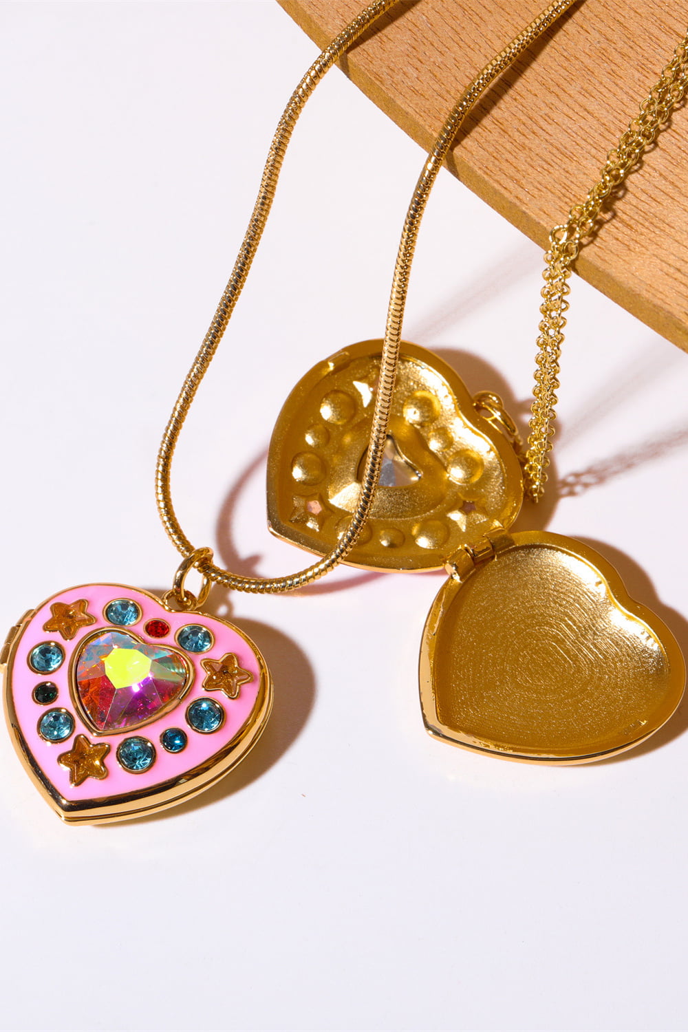 Gold-tone heart box pendant necklace with pink heart, rhinestones, and multicolor gem charms
