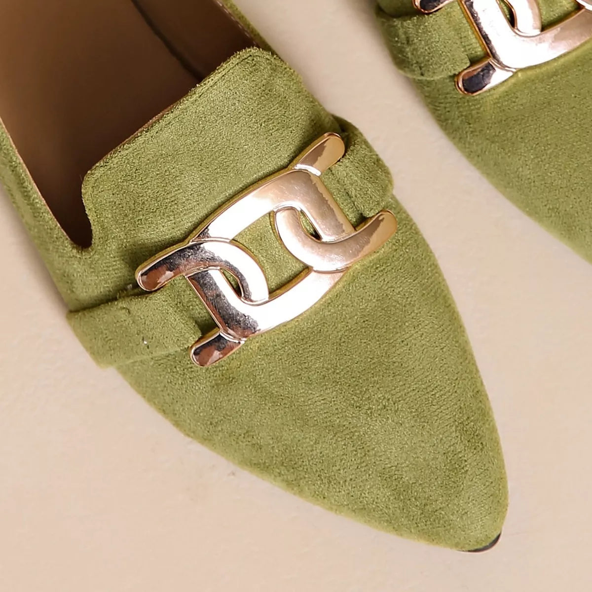 Matcha green suede pointed toe loafer with close-up chain link buckle