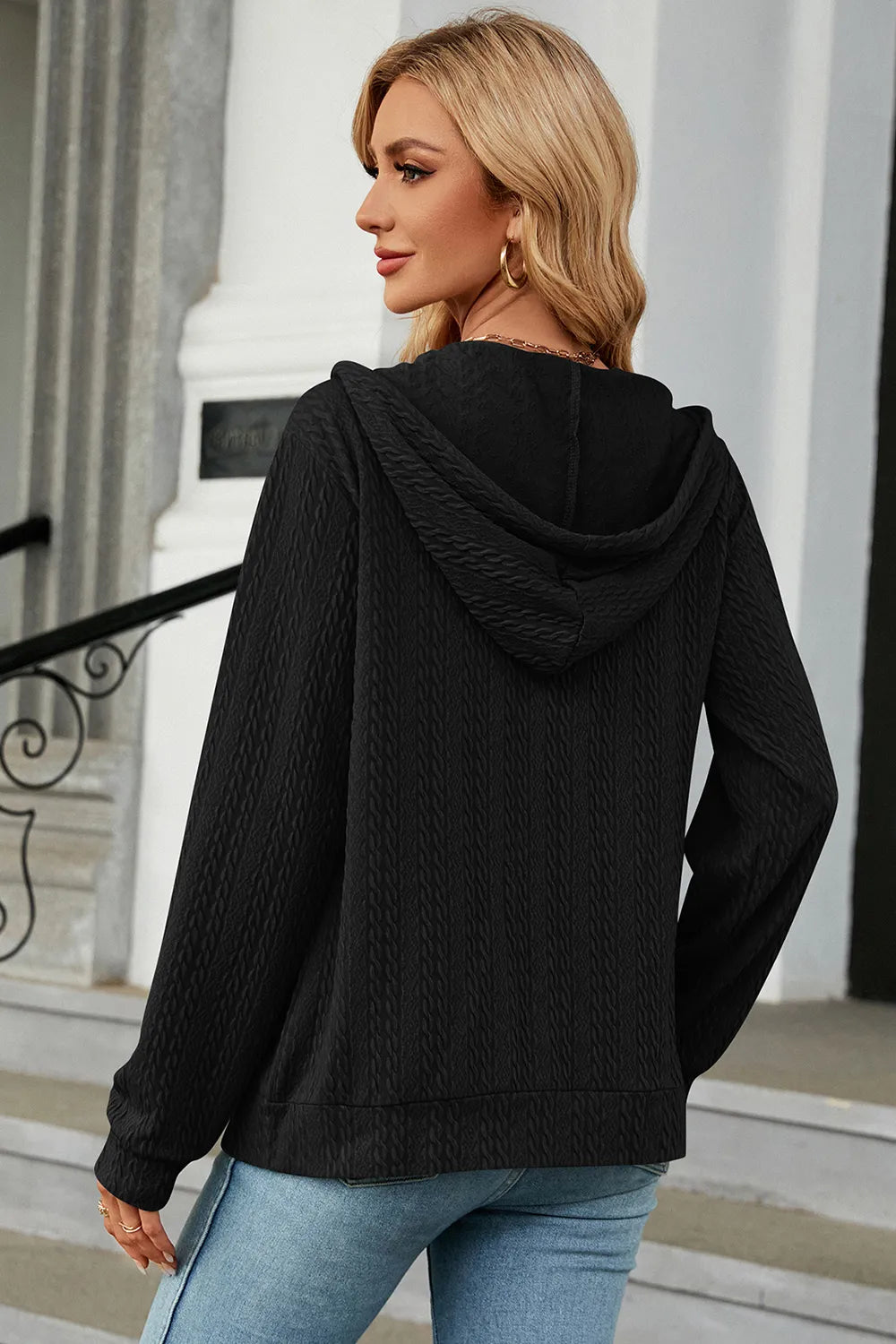 Black drawstring zip-up hoodie, hooded back view with ribbed cuffs and hem