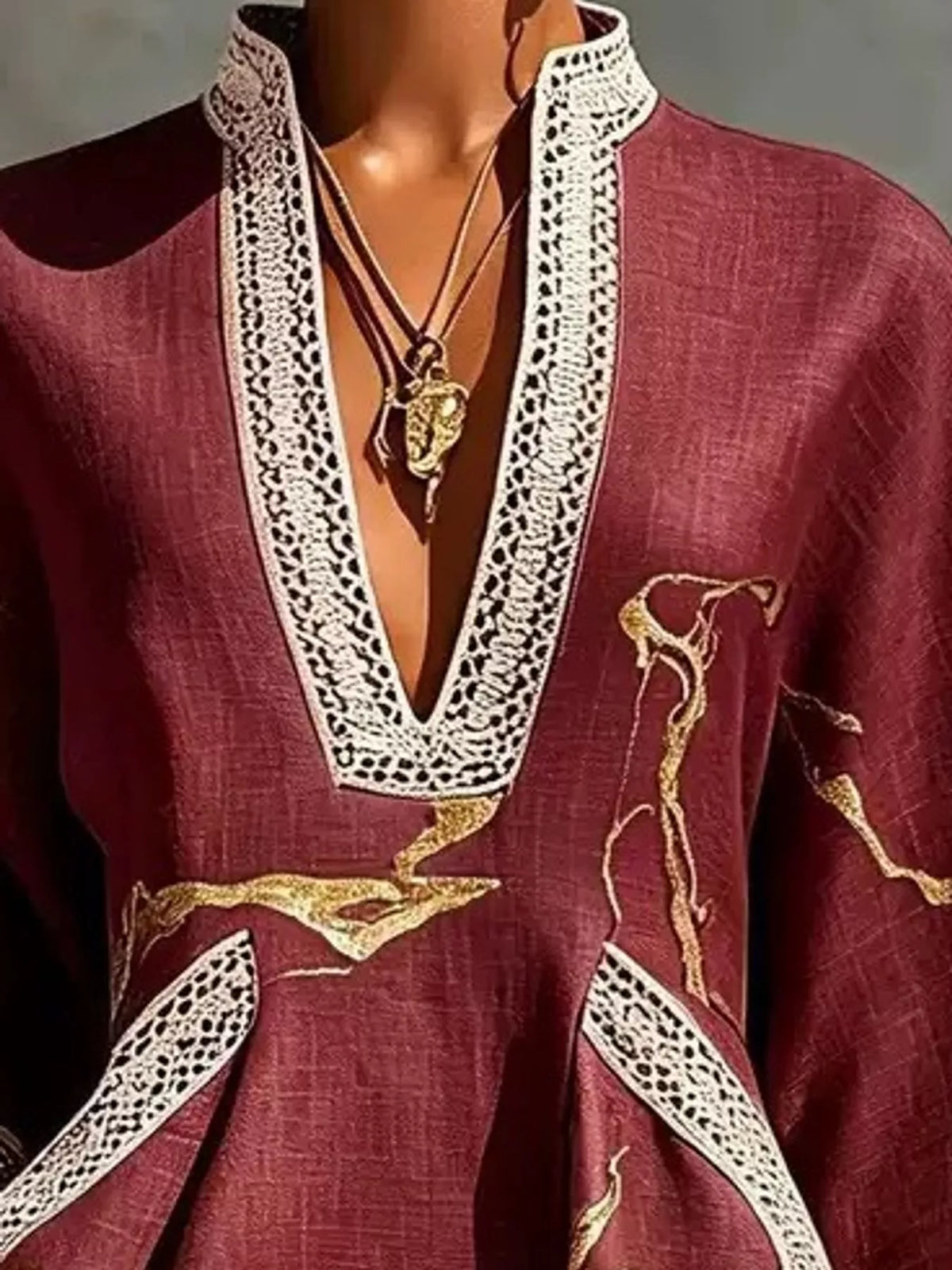 Burgundy mini dress with V-neck white lace trim and gold motif print