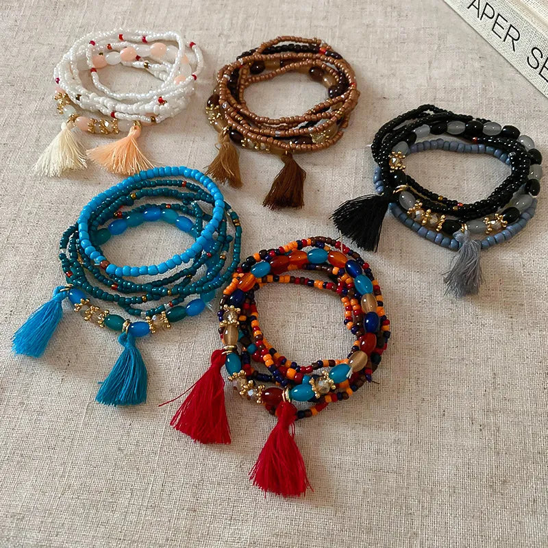 Beaded tassel bracelets assortment in blue, orange, brown, and black cords