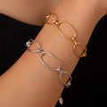 Stainless steel chain bracelet pair on wrist, gold and silver oval links