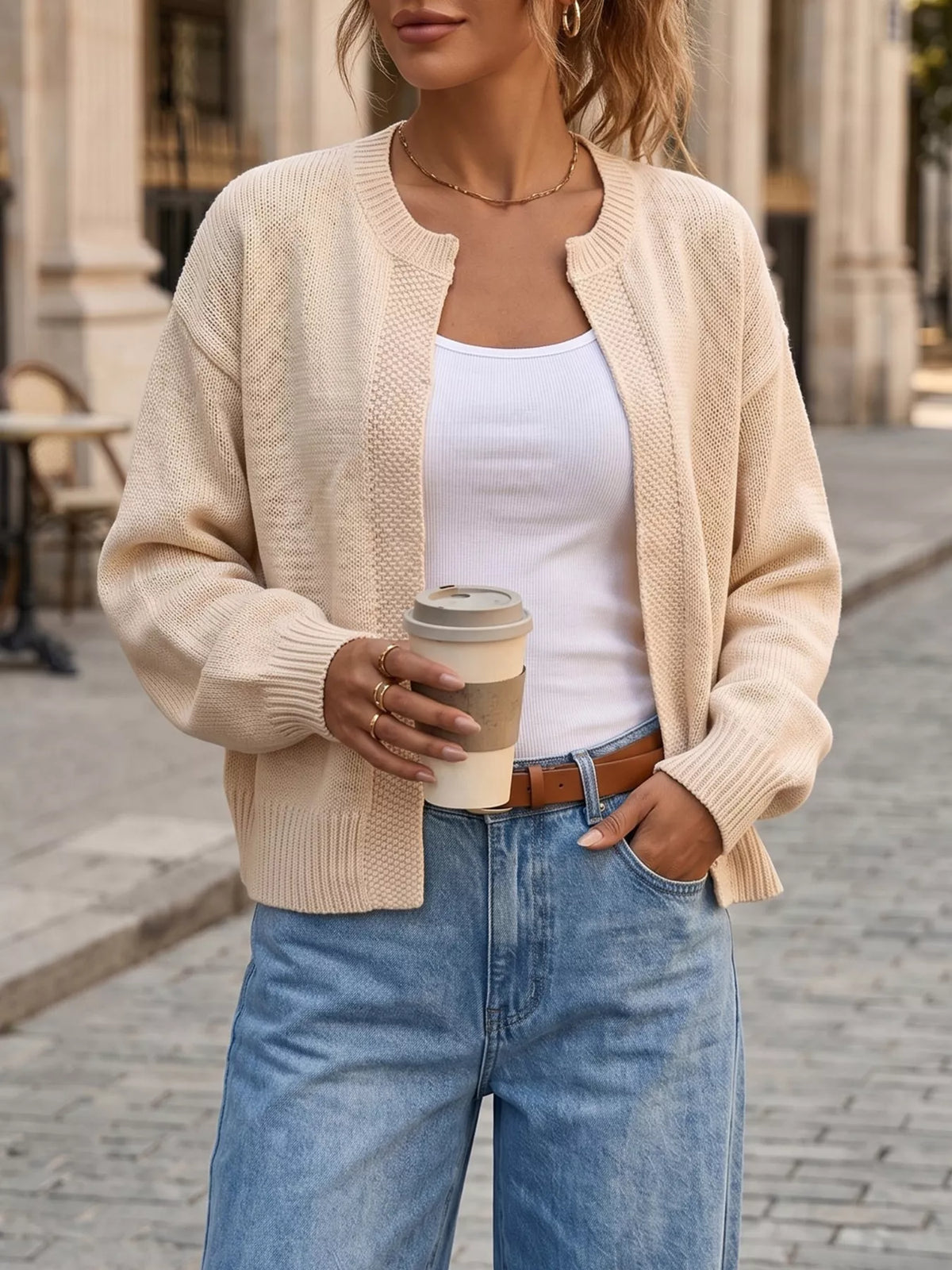 Cream knit open-front cardigan with ribbed trim and long sleeves