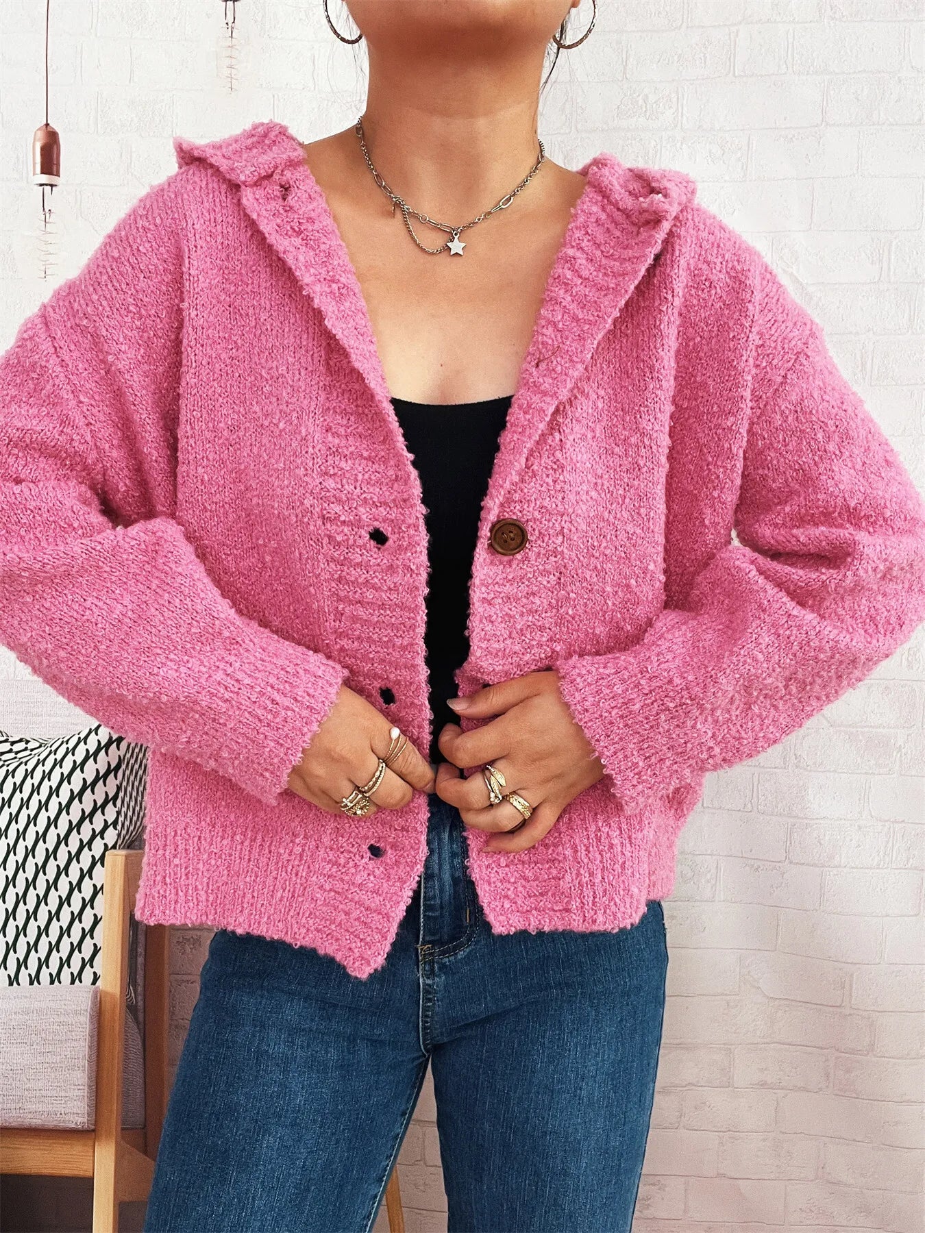 Pink hooded cardigan with long sleeves, button front, and soft textured knit