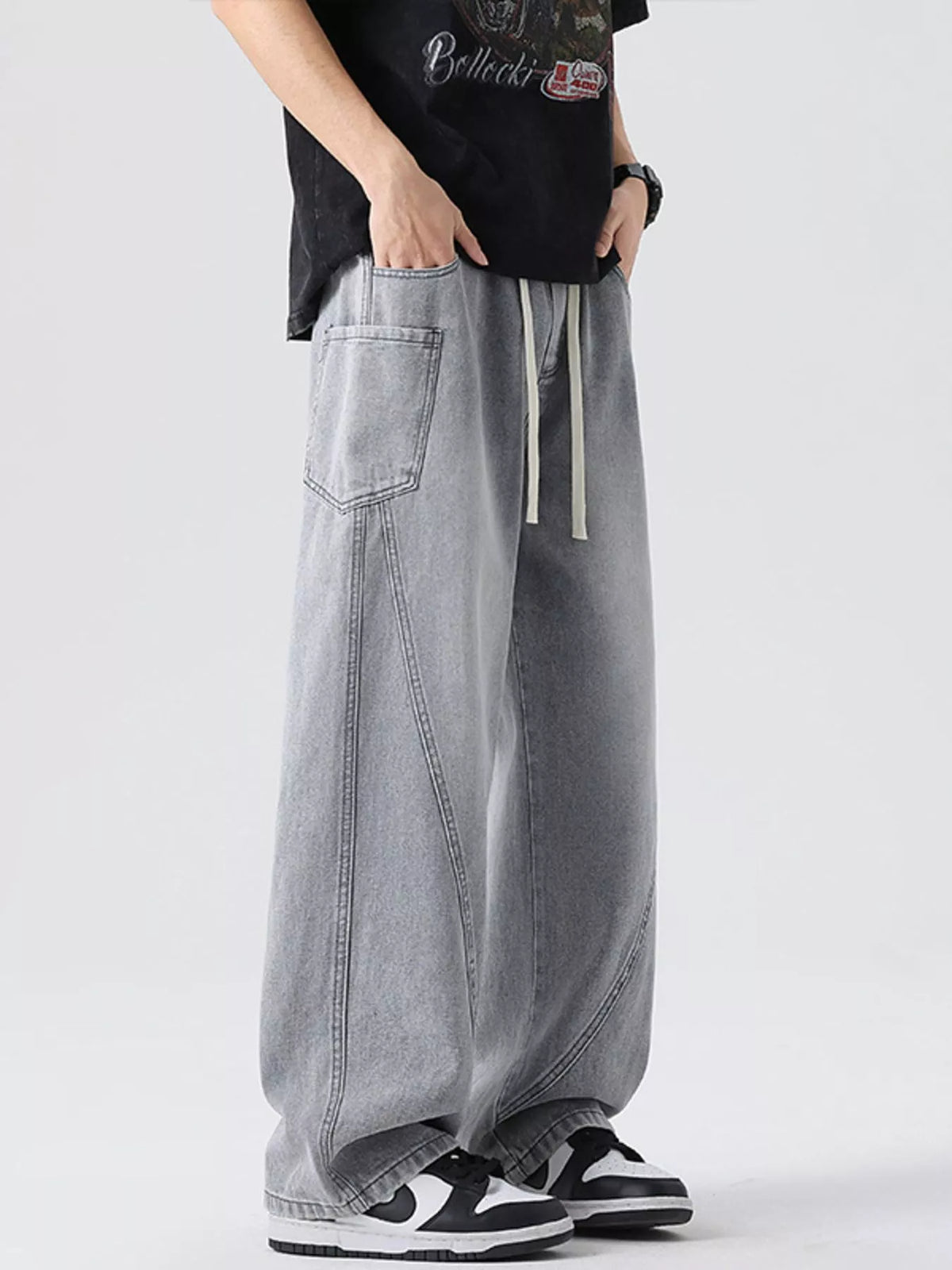 Men's vintage wide-leg jeans in medium gray denim with drawstring waist, baggy silhouette.