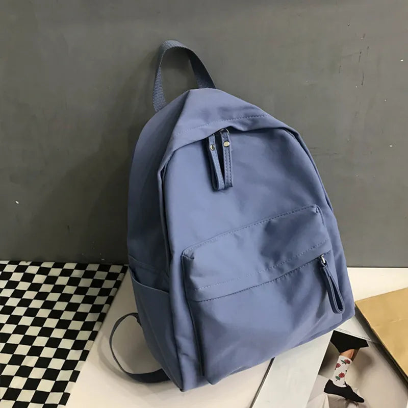 Zip cotton backpack, light blue fabric with front zip pocket and adjustable straps