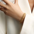 Gold chain bracelet with interwoven links on wrist