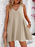 Sand V-neck sleeveless mini dress with pleated skirt and draped front
