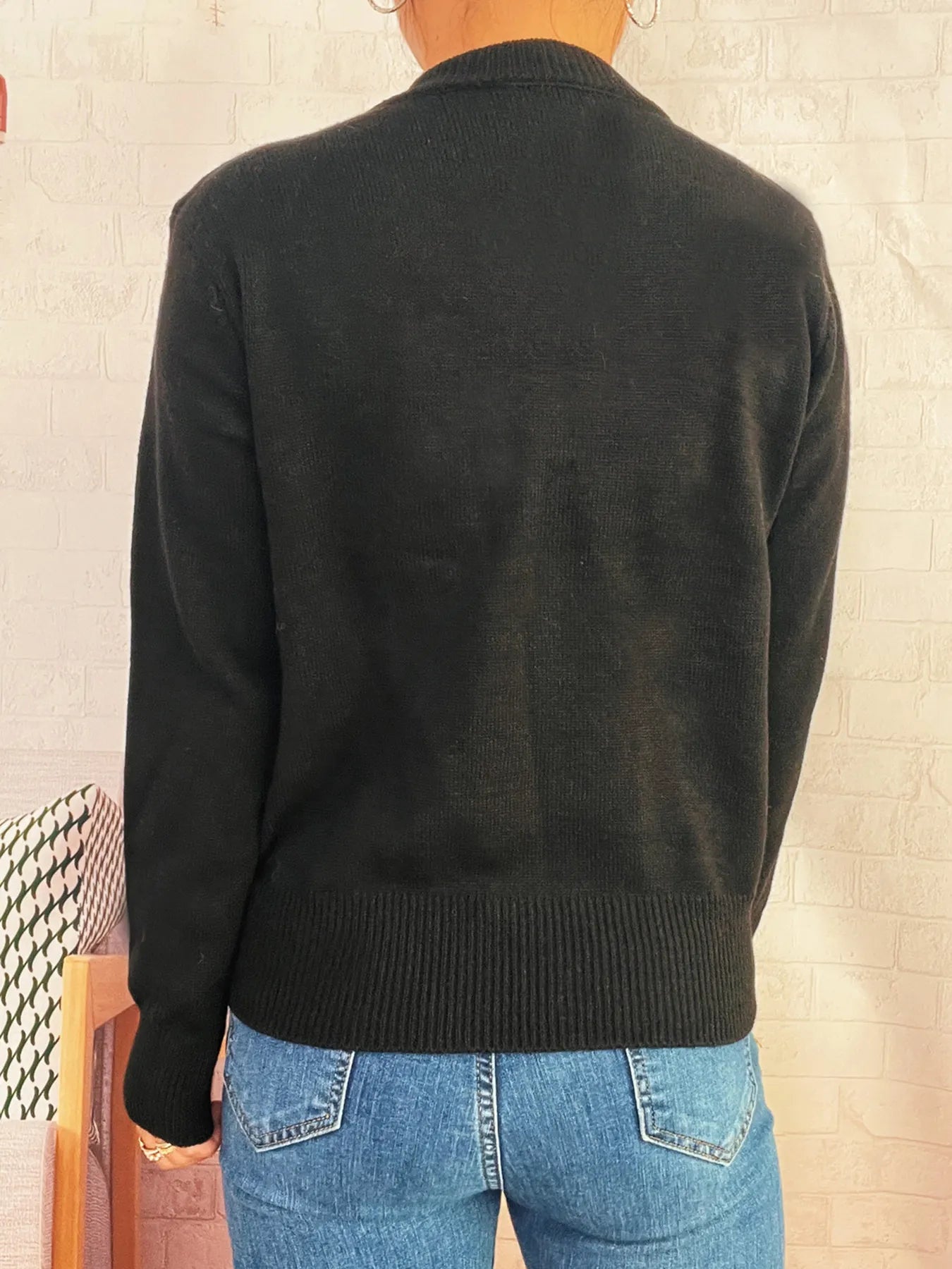 Black button-front cardigan back view, ribbed hem and cuffs