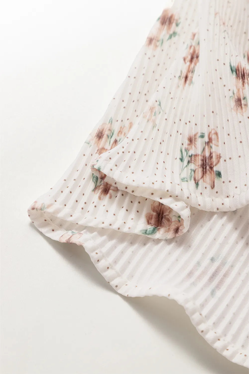 Floral cami hem detail, white with small floral print and soft drape