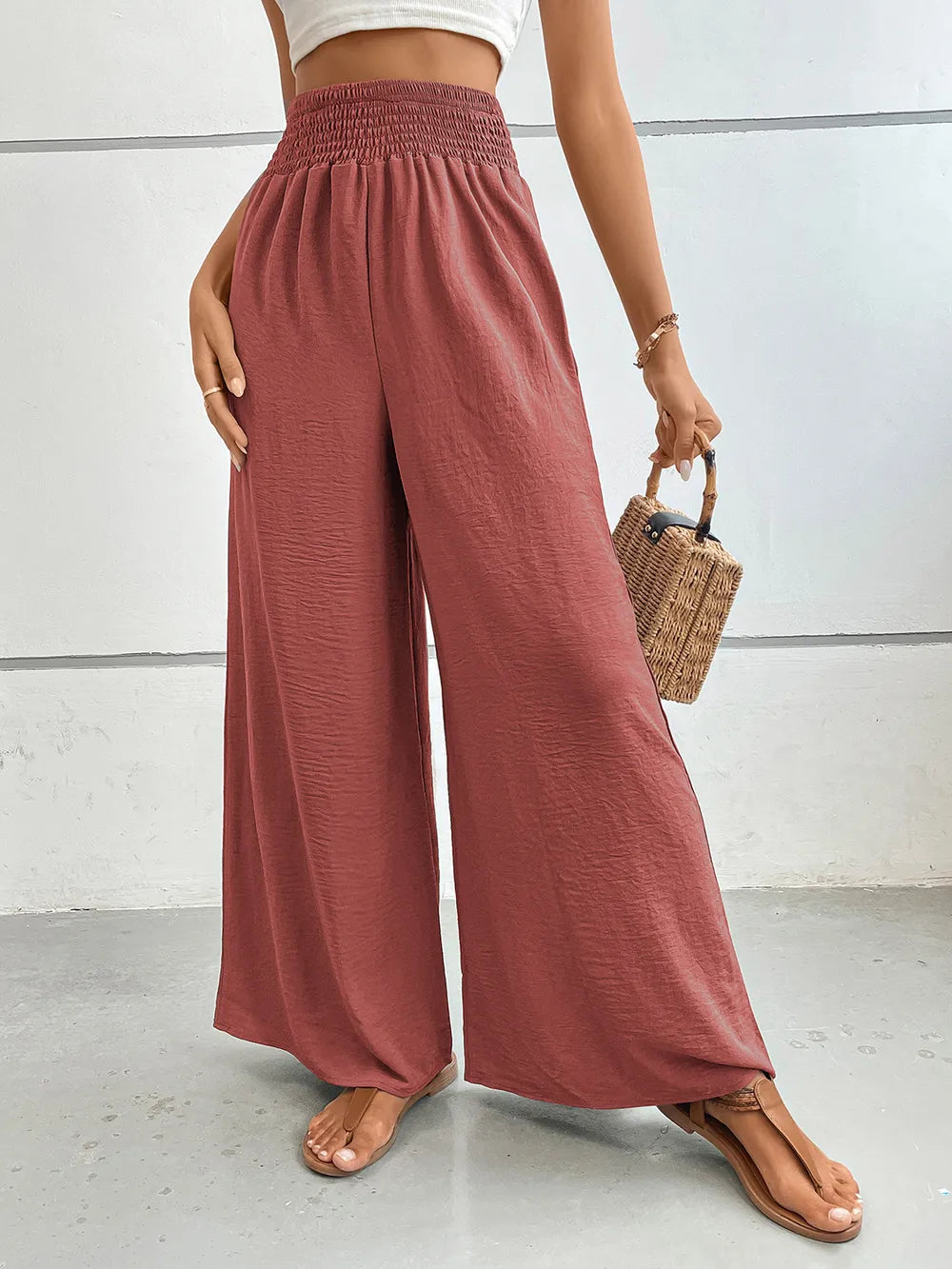 Wide-leg pants in dusty rose pink with elastic waistband and wide flowing legs