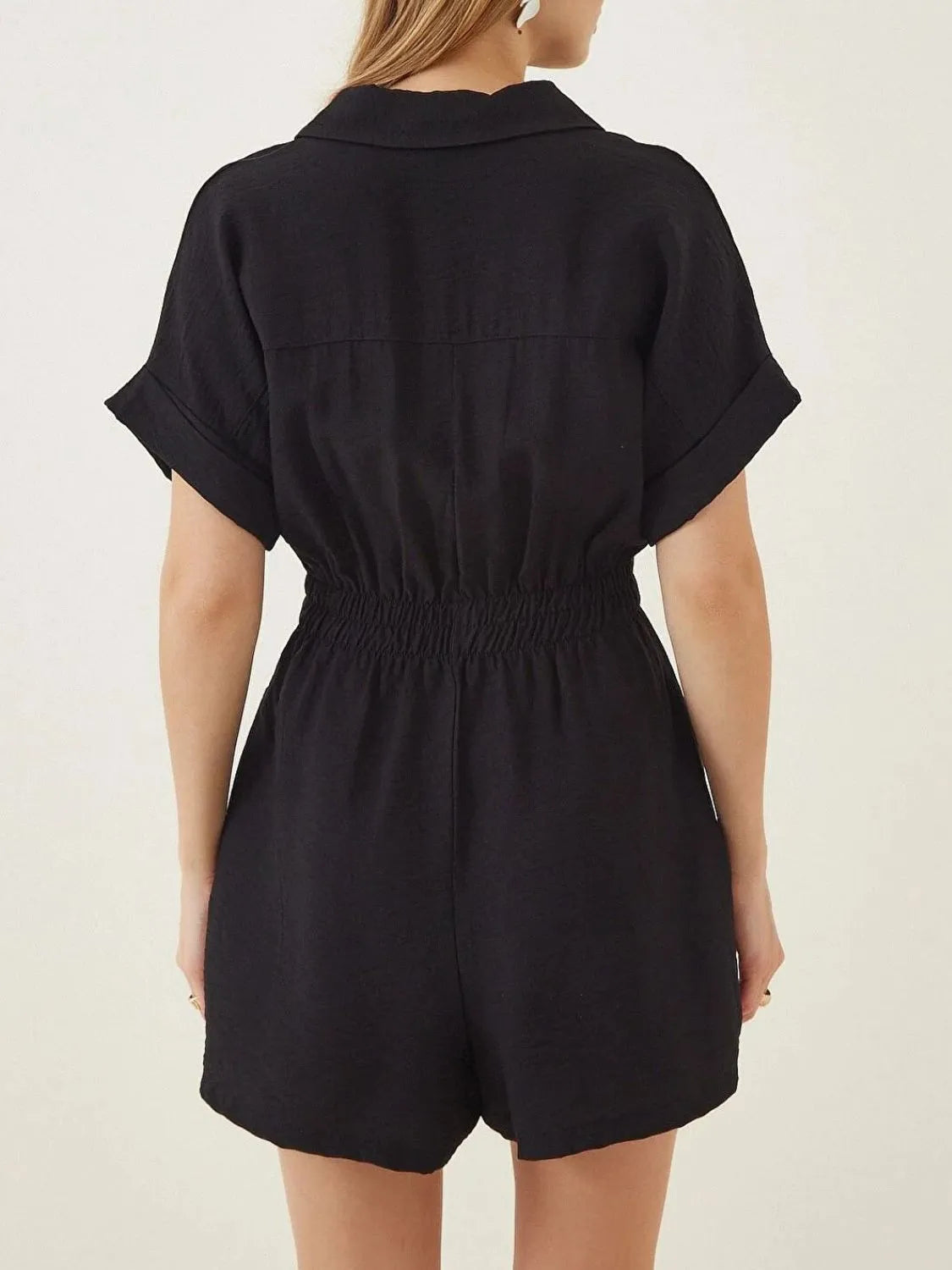 Black collar short-sleeve romper, back view with yoke seam and elastic waist