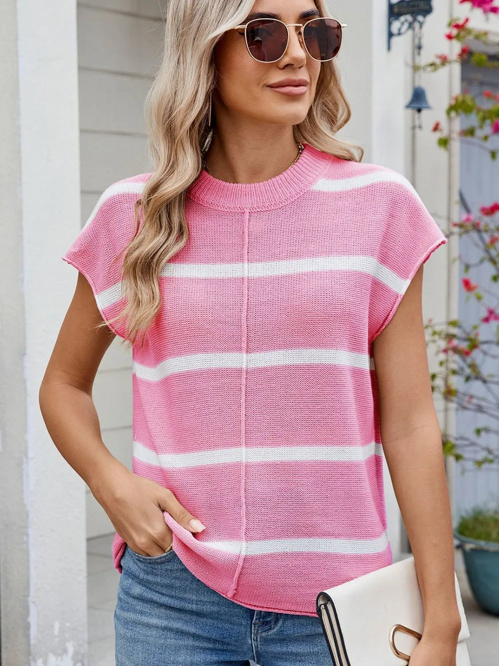 Pink striped knit top with exposed seam and round neck, short sleeves, white stripes