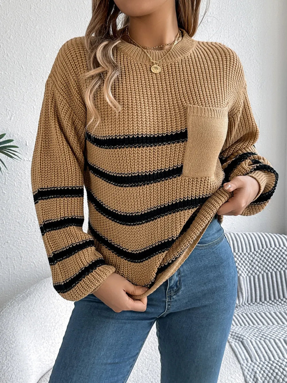 Caramel striped knit sweater with round neck, long sleeves, and chest pocket