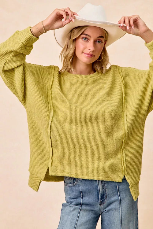 Lime green knit sweater with uneven hem and open seams, ribbed crew neck
