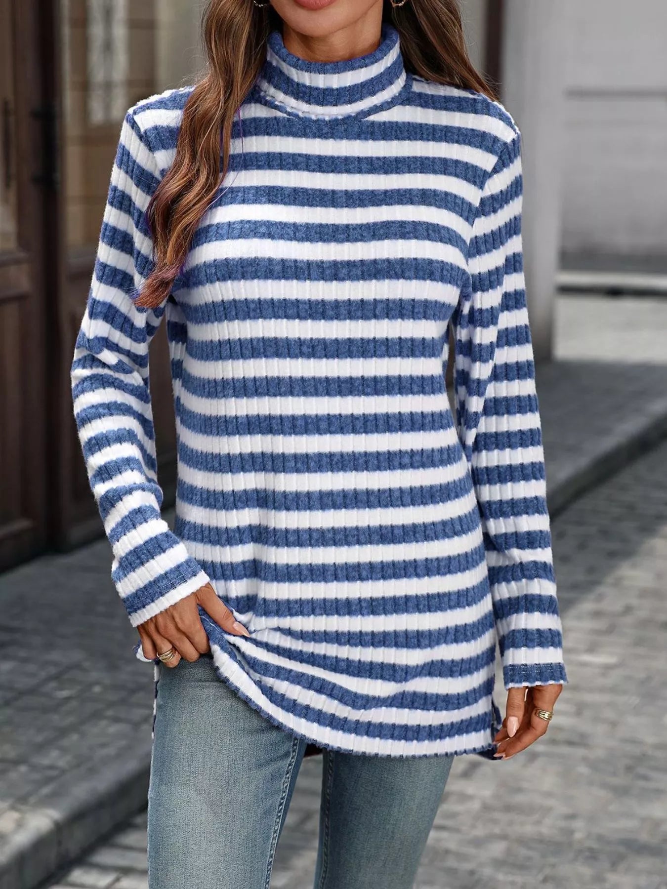 Blue and white striped rib-knit turtleneck long-sleeve top with straight hem.