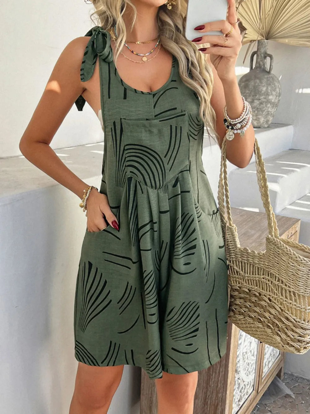 Printed tie-shoulder overall dress in deep green with black abstract pattern and pockets