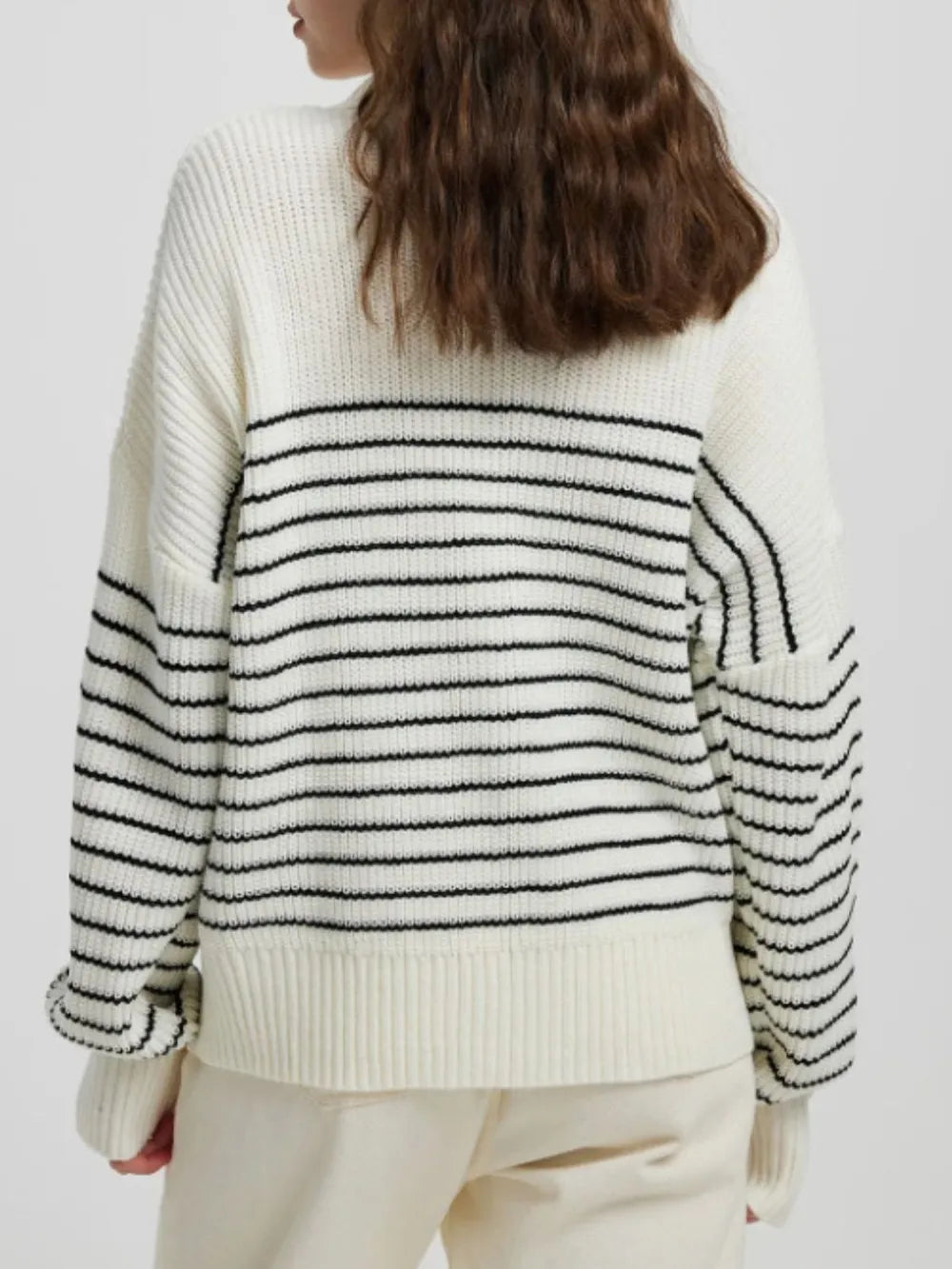 Cream striped half-zip knit sweater, long sleeves with black stripe bands on cuffs