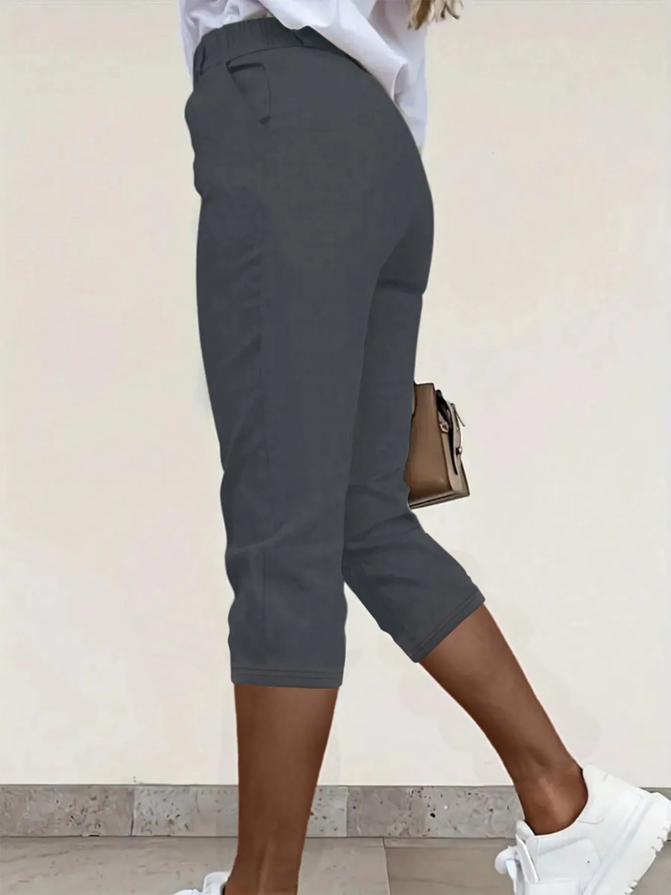 Dark gray pleated capri pants with pockets and belt loops