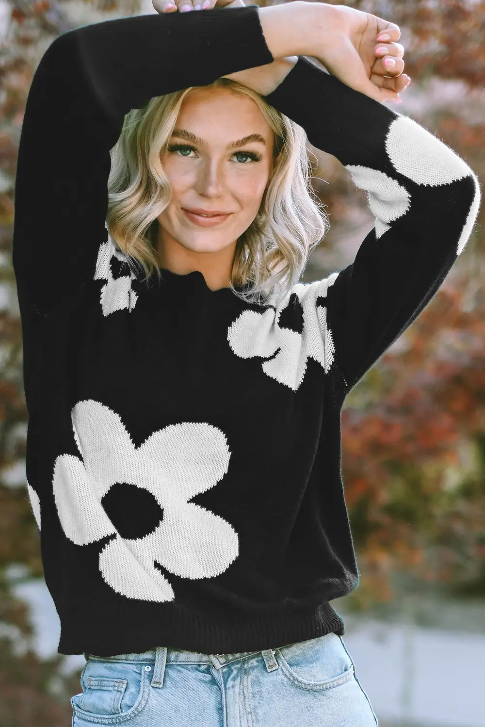 Black long-sleeve sweater with large white floral design on the front