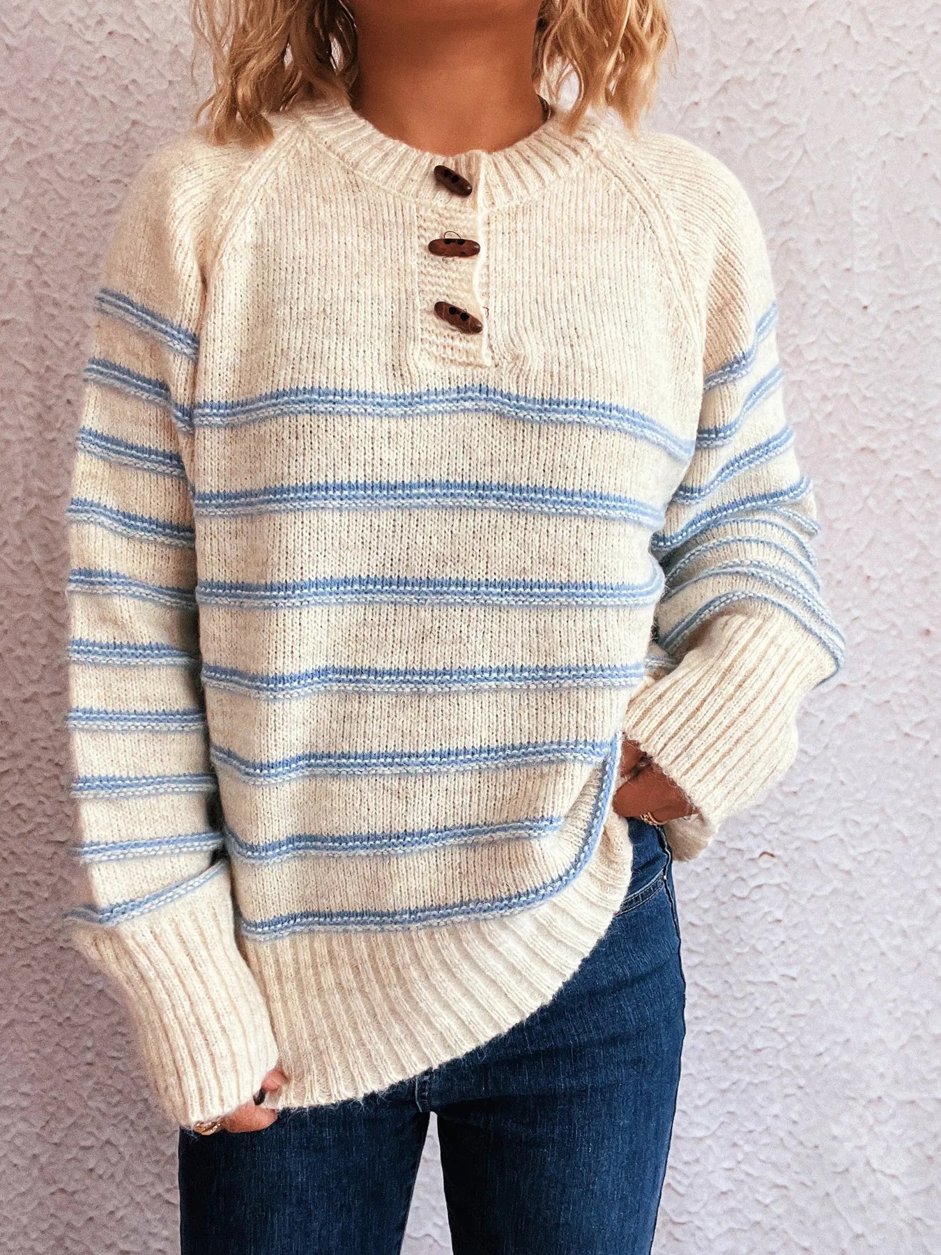 Cream striped long sleeve sweater with button placket and ribbed cuffs, blue stripes