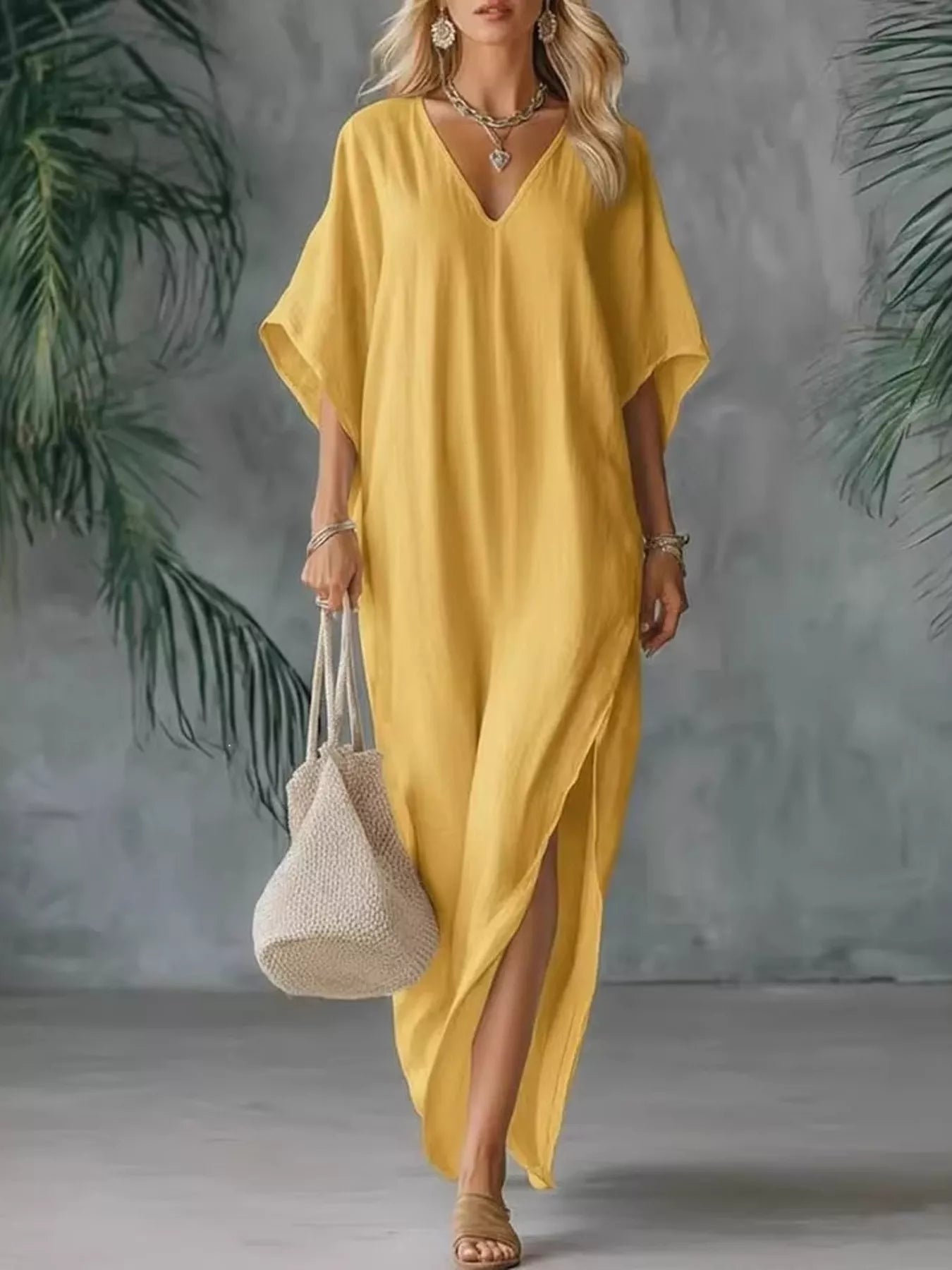 Yellow V-neck maxi dress with short sleeves and side slits, relaxed draped silhouette