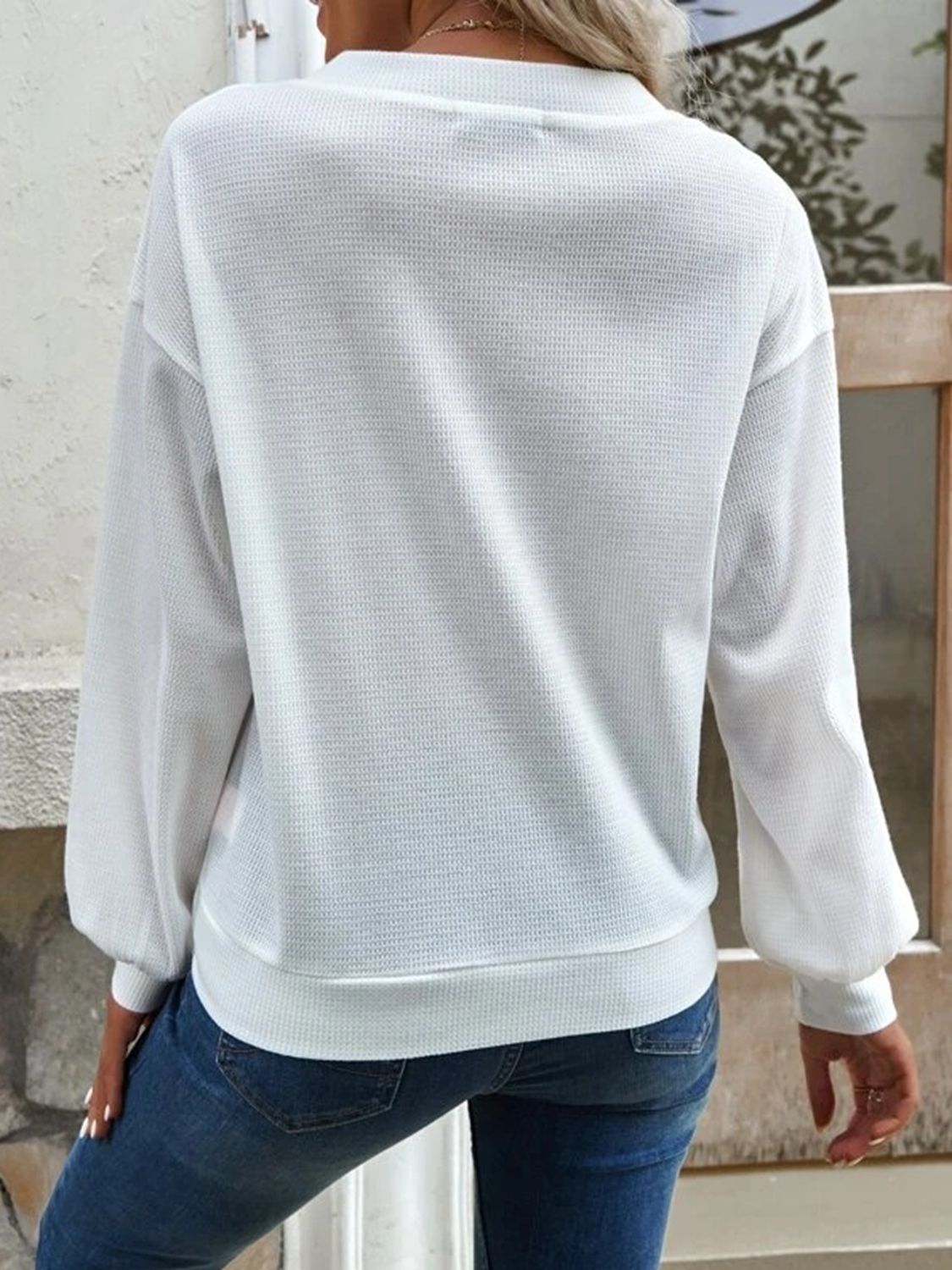 White V-neck blouse back view with long sleeves and dropped-shoulder shape