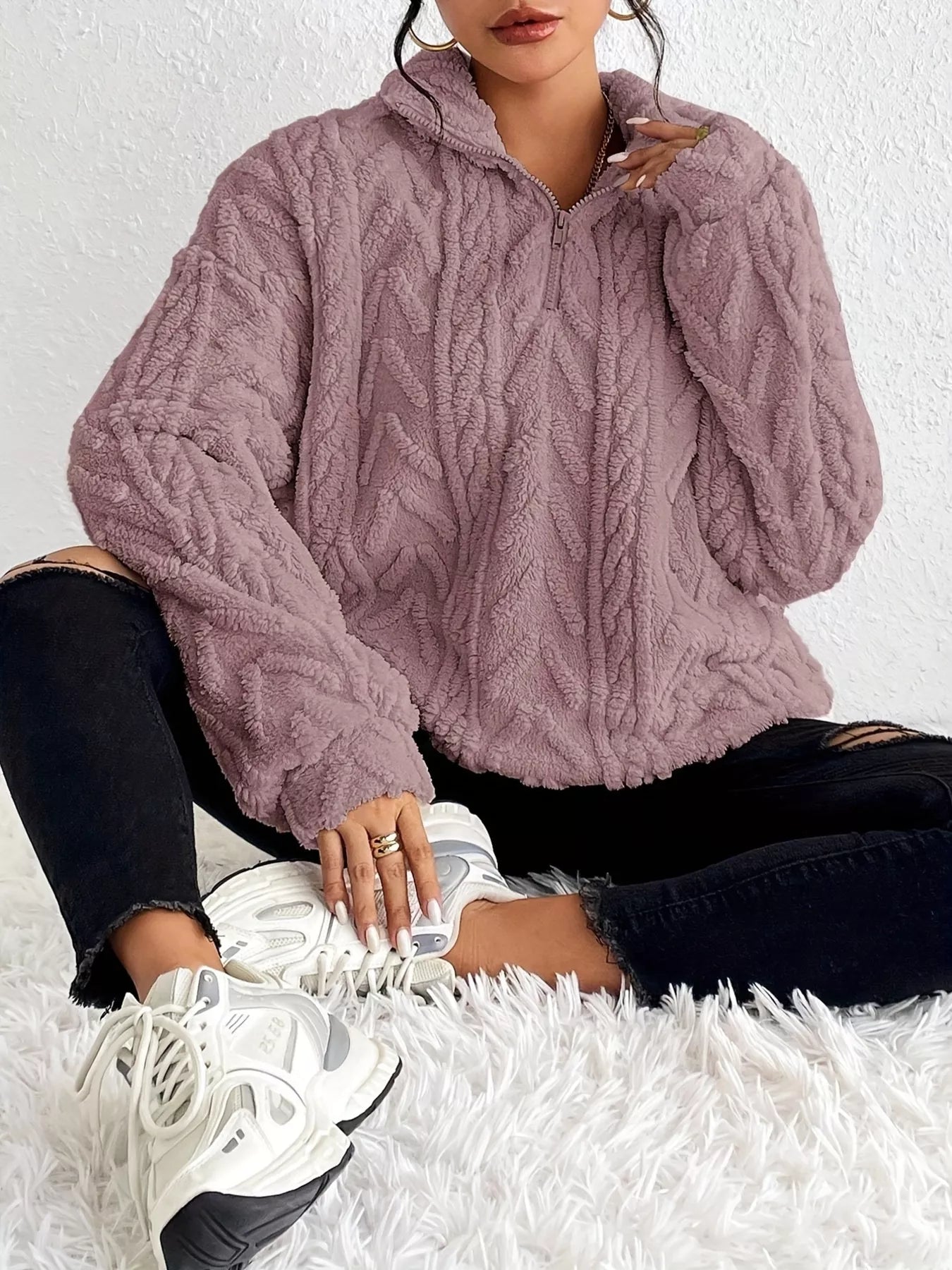 Light purple sherpa quarter-zip sweatshirt with cable knit pattern and wide sleeves
