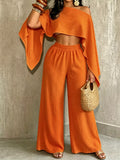Orange boat-neck crop top with wide-leg pull-on pants, loose flowing set.